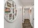Hallway showcasing a decorative circular Gathering photo frame and wood floors at 5741 91St N Ave, Pinellas Park, FL 33782
