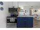 Kitchen featuring updated appliances, a modern cooktop, and an island with seating at 5741 91St N Ave, Pinellas Park, FL 33782