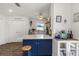 Bright kitchen features a blue island with white countertop, white cabinets, and stainless steel appliances at 5741 91St N Ave, Pinellas Park, FL 33782