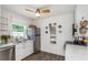 Bright and functional kitchen with white cabinets, stainless steel appliances, and decorative backsplash at 5741 91St N Ave, Pinellas Park, FL 33782