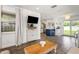 Open living space featuring wood floors, modern furnishings, and an open layout to the kitchen and backyard at 5741 91St N Ave, Pinellas Park, FL 33782