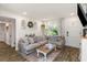 Cozy living room showcasing a large sectional sofa, accent decor, and a rustic coffee table at 5741 91St N Ave, Pinellas Park, FL 33782
