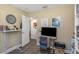 Home office with desk and chair, laminate floors, and an open doorway at 5741 91St N Ave, Pinellas Park, FL 33782