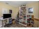 Home office with a full bookcase, desk, laminate floors, rocking chair and wall decorations at 5741 91St N Ave, Pinellas Park, FL 33782