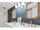 Stylish bathroom with herringbone tile, double sinks, and rope-framed mirrors at 602 Lime Ave # 102, Clearwater, FL 33756