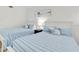 Bright bedroom with two twin beds featuring striped bedding and white wood furniture at 602 Lime Ave # 102, Clearwater, FL 33756