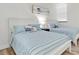 Bright bedroom with two twin beds featuring striped bedding and white wood furniture at 602 Lime Ave # 102, Clearwater, FL 33756