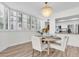 Bright dining area featuring a round table, shuttered windows, and chandelier adjacent to the kitchen at 602 Lime Ave # 102, Clearwater, FL 33756