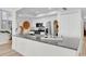 Bright kitchen has stainless appliances and a granite island with a gold faucet at 602 Lime Ave # 102, Clearwater, FL 33756