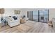 Living room showcasing a comfortable white sofa, natural rug, and balcony with ocean views at 602 Lime Ave # 102, Clearwater, FL 33756