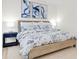 Comfortable main bedroom with a woven bed frame, coastal artwork, and bedside tables at 602 Lime Ave # 102, Clearwater, FL 33756