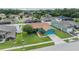 Aerial shot showcases the property's well-manicured lawn, mature trees, and neighborhood setting at 7046 Frascati Loop, Wesley Chapel, FL 33544