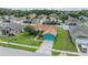 Aerial shot showcases the property's well-manicured lawn, mature trees, and neighborhood setting at 7046 Frascati Loop, Wesley Chapel, FL 33544