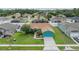 Aerial shot showcases the property's well-manicured lawn, mature trees, and neighborhood setting at 7046 Frascati Loop, Wesley Chapel, FL 33544