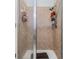 Tiled standing shower featuring glass doors and dual shower heads at 7046 Frascati Loop, Wesley Chapel, FL 33544