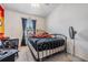 Cozy bedroom with an iron bed frame, carpeted floor, and natural light at 7046 Frascati Loop, Wesley Chapel, FL 33544