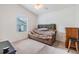 Bright bedroom featuring a comfortable sofa and a window with natural light at 7046 Frascati Loop, Wesley Chapel, FL 33544