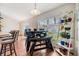 Bright dining area features modern furnishings, natural light, and charming plant display at 7046 Frascati Loop, Wesley Chapel, FL 33544