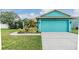 Eye-catching, vibrant blue single-Gathering home featuring a two-car garage and well-manicured lawn at 7046 Frascati Loop, Wesley Chapel, FL 33544