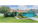 Attractive single-Gathering home with manicured lawn, mature trees, and attached garage at 7046 Frascati Loop, Wesley Chapel, FL 33544