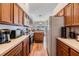 Efficient kitchen featuring ample counter space, wooden cabinets, and essential appliances at 7046 Frascati Loop, Wesley Chapel, FL 33544