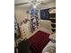 Functional bedroom features a ceiling fan, black out window shade, and black storage containers at 714 Gray S St, Gulfport, FL 33707