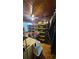 Cluttered bedroom with a wood-paneled ceiling, a desk, and numerous storage bins at 714 Gray S St, Gulfport, FL 33707