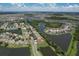 Aerial view showcasing the property's proximity to lakes and surrounding community at 7254 Parkersburg Dr, Wesley Chapel, FL 33545