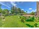 Spacious backyard with lush green grass, a wood fence, a shed and a patio in a serene residential setting at 7254 Parkersburg Dr, Wesley Chapel, FL 33545