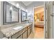 Elegant bathroom with granite countertops, double sinks, and a view into the bedroom at 7254 Parkersburg Dr, Wesley Chapel, FL 33545