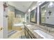 Bright bathroom showcasing a granite-topped vanity with double sinks, a soaking tub, and a glass-enclosed shower at 7254 Parkersburg Dr, Wesley Chapel, FL 33545