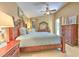 Spacious primary bedroom features a vaulted ceiling, a ceiling fan, and elegant furnishings at 7254 Parkersburg Dr, Wesley Chapel, FL 33545