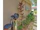 Home exterior featuring a water filtration system, attached to the side of the home, near decorative landscaping at 7254 Parkersburg Dr, Wesley Chapel, FL 33545