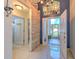 A sunlit foyer reveals an inviting scene looking out to the home's manicured front yard at 7254 Parkersburg Dr, Wesley Chapel, FL 33545