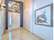 Bright foyer featuring tiled floors, a decorative painting, and an overhead transom window at 7254 Parkersburg Dr, Wesley Chapel, FL 33545
