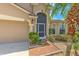 Home's exterior showcasing its appealing facade, including the front door, garage, and tidy landscaping at 7254 Parkersburg Dr, Wesley Chapel, FL 33545