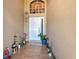 Inviting front entrance with decorative plants, tiled floor, and a charming welcome mat at 7254 Parkersburg Dr, Wesley Chapel, FL 33545