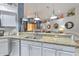 Open kitchen with granite countertops, stainless steel appliances, and pendant lighting at 7254 Parkersburg Dr, Wesley Chapel, FL 33545