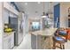Open concept kitchen with granite countertops, stainless steel appliances, and adjacent breakfast bar at 7254 Parkersburg Dr, Wesley Chapel, FL 33545