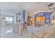 Open-concept living area with high ceilings, modern decor, and seamless flow to the kitchen at 7254 Parkersburg Dr, Wesley Chapel, FL 33545