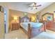 Spacious bedroom featuring a luxurious wood frame bed set and complementary decor at 7254 Parkersburg Dr, Wesley Chapel, FL 33545