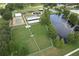 Aerial view of the neighborhood park featuring a playground, tennis court, and pond at 7254 Parkersburg Dr, Wesley Chapel, FL 33545