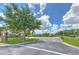 The entrance to Bridgewater Park features well-kept grounds, signage, and a paved road on a sunny day at 7254 Parkersburg Dr, Wesley Chapel, FL 33545