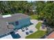 Aerial view showcases a backyard with a brick patio, seating areas, and lush greenery at 745 Bruce Ave, Clearwater Beach, FL 33767