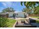 Beautiful backyard features patio seating and lush greenery at 745 Bruce Ave, Clearwater Beach, FL 33767