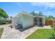 Well-maintained backyard with brick paver patio, screened porch, and lush lawn at 745 Bruce Ave, Clearwater Beach, FL 33767
