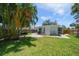 Spacious backyard featuring a brick patio, outdoor furniture, grill, and lush lawn at 745 Bruce Ave, Clearwater Beach, FL 33767