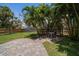 Serene backyard has brick-paved patio and shaded dining area at 745 Bruce Ave, Clearwater Beach, FL 33767