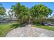 Private backyard features a large patio area with palm trees for added seclusion at 745 Bruce Ave, Clearwater Beach, FL 33767
