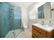 Modern bathroom featuring tiled shower, wood vanity with sink, and stylish fixtures at 745 Bruce Ave, Clearwater Beach, FL 33767